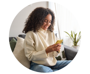Smiling woman sat looking at weight management support on her phone